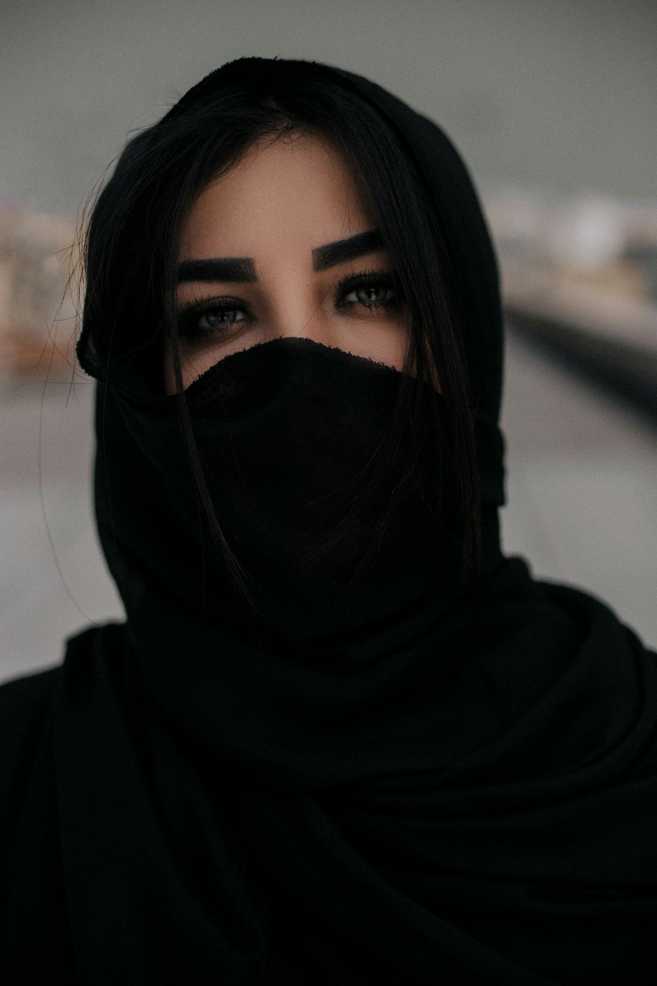 woman in black hijab taking selfie